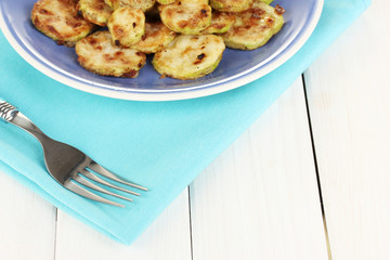 roasted squash in a blue bowl with fork