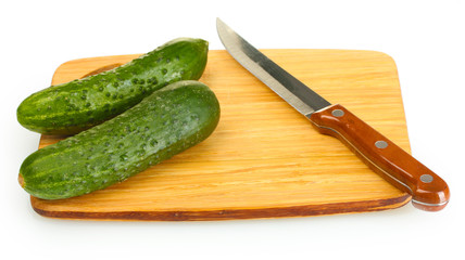 fresh cucumbers and knife on cutting board isolated on white