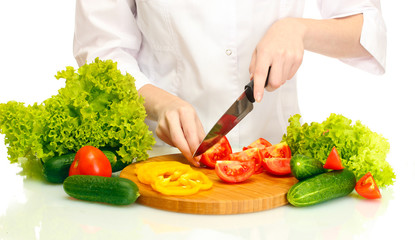 woman hands cutting vegetables on kitchen blackboard