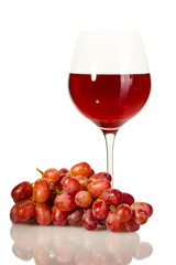 glass of wine and ripe grapes isolated on white