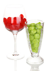 Color candies in glasses isolated on white