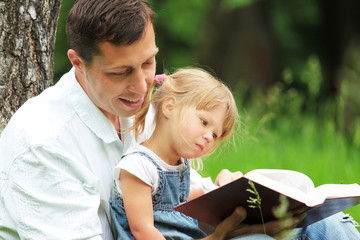 Father and daughter reading the Bible