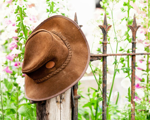 Bush hat on a railing with flowers