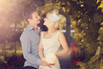 Wedding photo of the groom and the bride, looking against each o