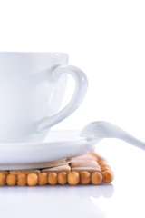 closeup shot. cup on plate with spoon