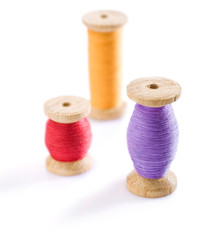 three spools with threads