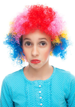 Sad little girl with party wig