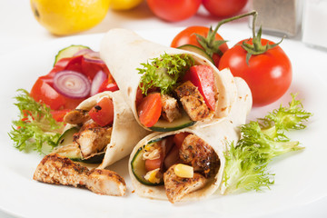 Grilled chicken and salad in tortilla wrap