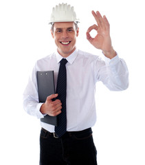 Handsome engineer showing okay gesture