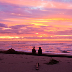 Romantic couple enjoy spectacular beach sunset