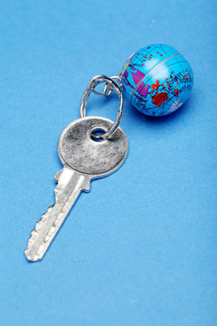 Globe And Key On Blue Background