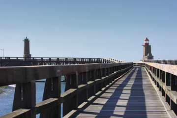 wooden pier and  lighthouse of the port of fécamps in france