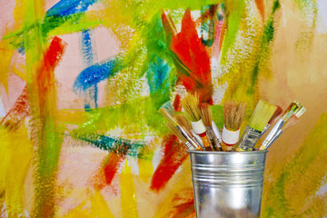 Obraz premium painting wall and brushes abstract concept