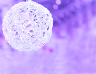 Christmas ball on the blurred purple background