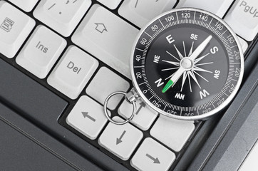 Computer keyboard and retro compass, business decision - 42481014