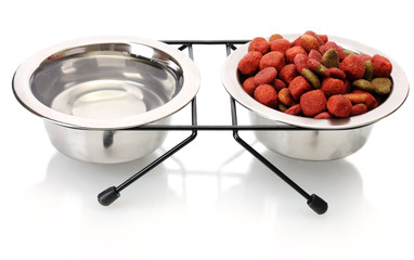 dry dog food and water in metal bowls isolated on white