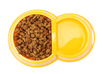 dry cat food and water in yellow bowl isolated on white