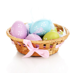 Colorful easter eggs in basket isolated on white