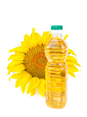 Blooming sunflowers and a bottle of vegetable oil