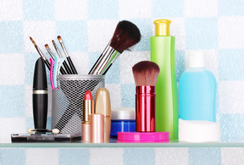 Shelf with cosmetics and toiletries in bathroom