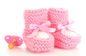 pink baby boots and pacifier isolated on white