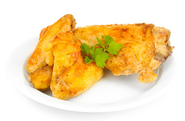 roasted chicken wings and leg with parsley in the plate