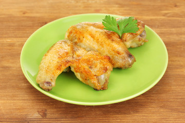 roasted chicken wings with parsley in the plate