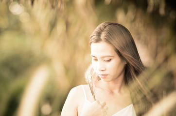 Asian Girl at grass field at sunset. Photo in old image style