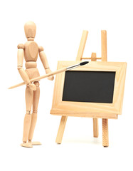Wooden artist mannequin with brush in pose with wood frame