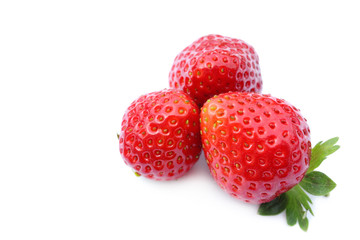 three fresh strawberries on white