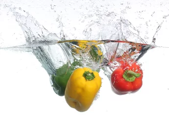 Crédence de cuisine en verre imprimé Éclaboussures deau Trois poivrons tombant dans l& 39 eau, sur fond blanc