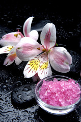 Obraz na płótnie Canvas Red bath salt in bowl and beautiful orchid and stone