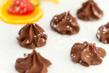 Small Tartufoes chocolate in an elegant dish.