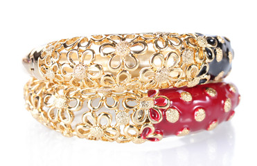Beautiful golden bracelets isolated on white