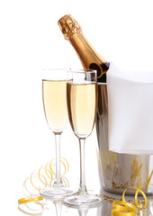 Champagne bottle in bucket with ice and glasses of champagne,