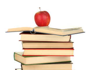 Tower of books with apple on white background close-up
