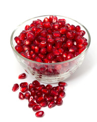 pomegranate in bowl isolated on white