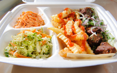 Tray with deep-fried potatoes,salads and meat