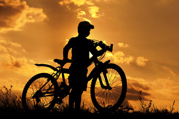 cyclist silhouette on a orange sky