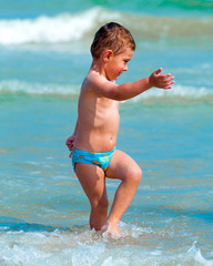 boy playing near the sea