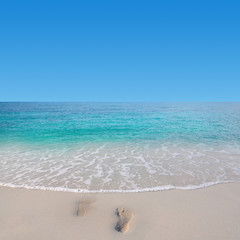 Footprint on the beach with nice sea and sky