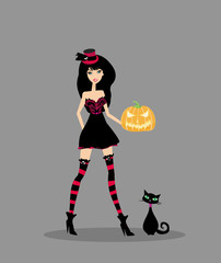 Halloween witch standing with pumpkin