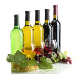 bottles and glasses of wine and ripe grapes isolated on white