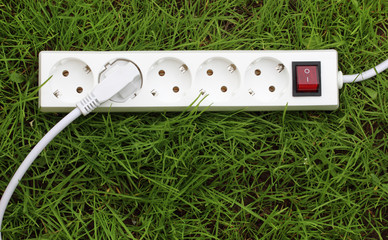 an power strip lying on the grass