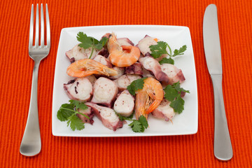 seafood salad with parsley on white plate