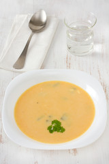 vegetable soup with parsley in white plate