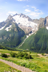 Obraz premium The river flows from the glacier in Dombay, Russia