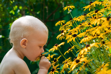 Baby smells the flowers