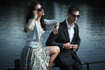 Young, smiling couple wearing sunglasses
