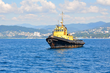 Fototapeta premium Yellow sea tow on anchor parking on spot-check of Sochi